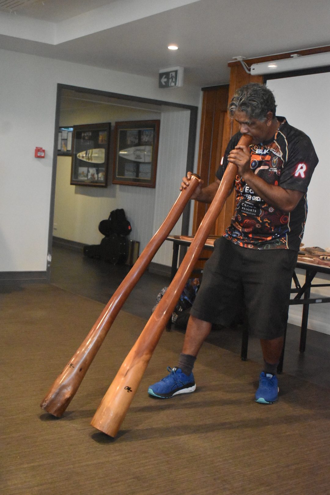 A man playing a didgeridoo.