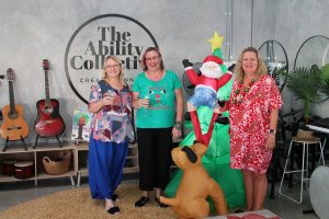 Ladies standing next to inflatable Christmas tree