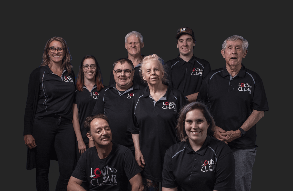 Portrait of nine Loud and Clear Qld members in the Loud and Clear Qld t-shirts.